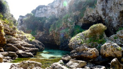 Small cala in Menorca with crystal clear blue water